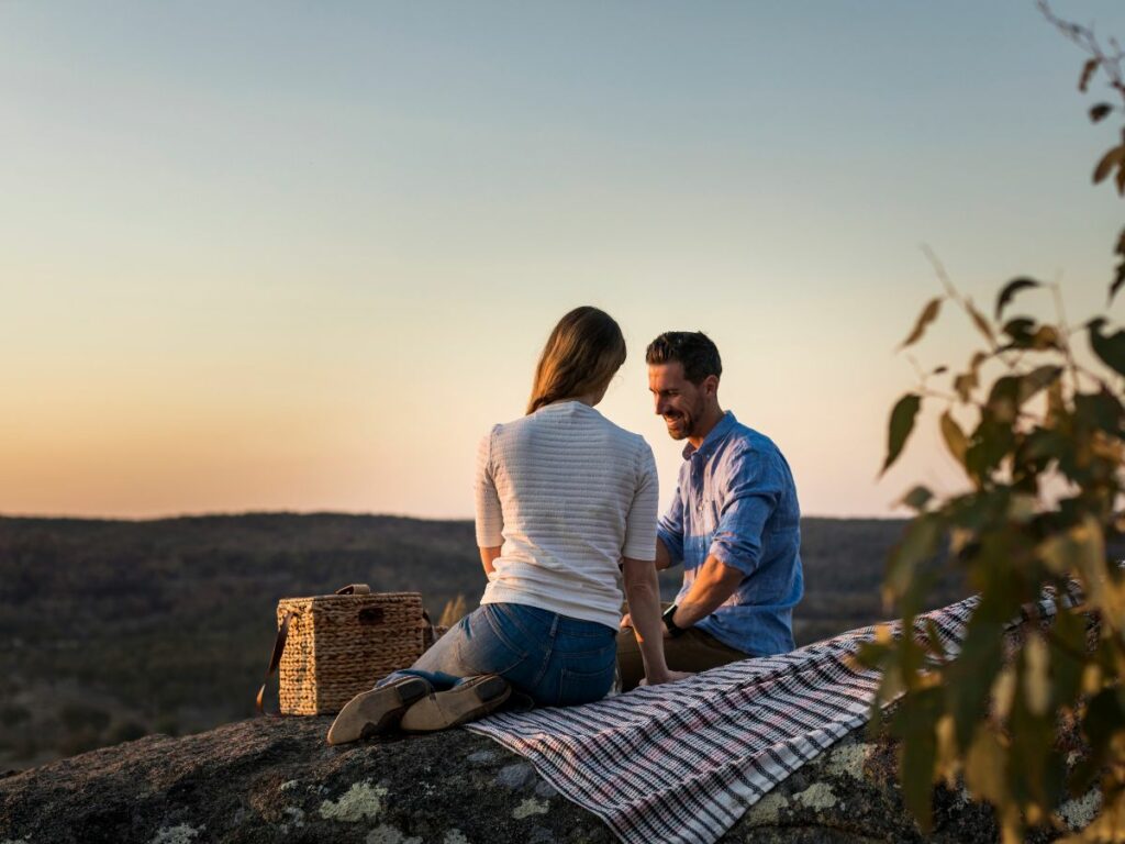 Couple having sunset picnic in Granite Belt Wine Country. Queensland.